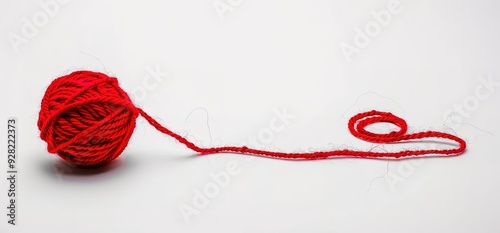 A ball of red yarn on a white background. The yarn is unraveled and a long string is extended out to the right.