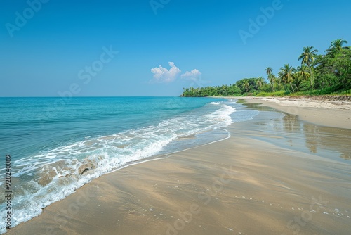 Wide Shot of Pristine White Sands and Turquoise Waters at Stout Beach, Kerala, India, with Clear Blue Sky