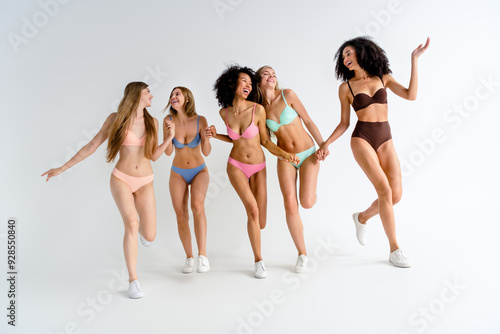 Full size photo no retouch of young women pose models shopping hold hands friends run wear lingerie natural day light studio background