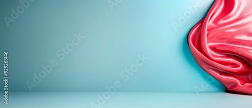  A red vase atop a table, adjacent to a light blue wall, with a blue wall as its background