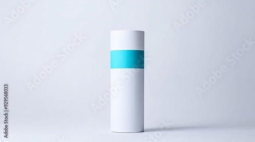 A contemporary product package with a minimalist design and a pop of color. The package is a simple, cylindrical tube made of matte white cardboard. The white label is printed with a bold, colorful