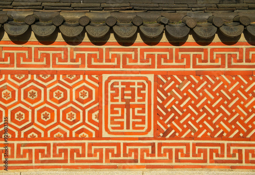 Jongno-gu, Seoul, South Korea - April 15, 2022: Front view of traditional patterns on the wall with tile roof at Unhyeongung Palace