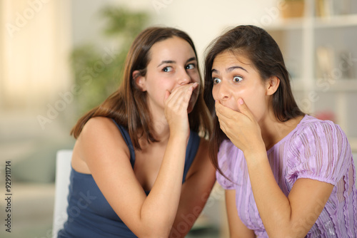 Gossip woman telling secret to her friend