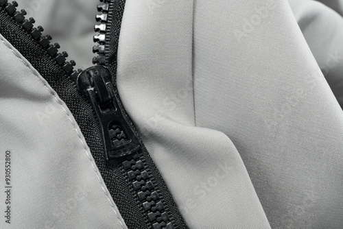 Silver lock with black zipper on clothes close-up. Zipper