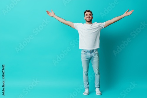 Happy man showing empty space on blue backdrop, demonstrating with joy and cheerfulness