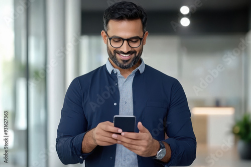 young handsome man using smartphone at office