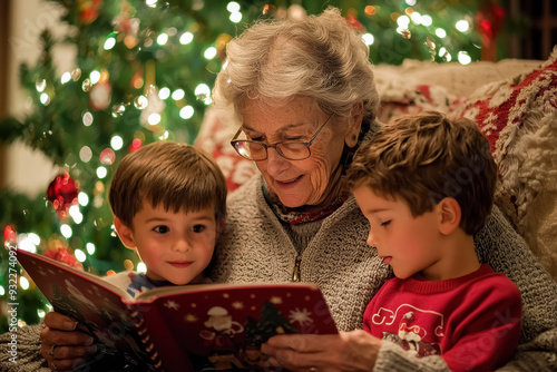 Family Bonding During Christmas Storytime. An elderly woman and two young boys enjoying a holiday story together, creating cherished memories in front of a beautifully lit Christmas tree. 