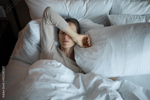 Young woman waking up in the morning feeling tired suffering from insomnia bad sleep 