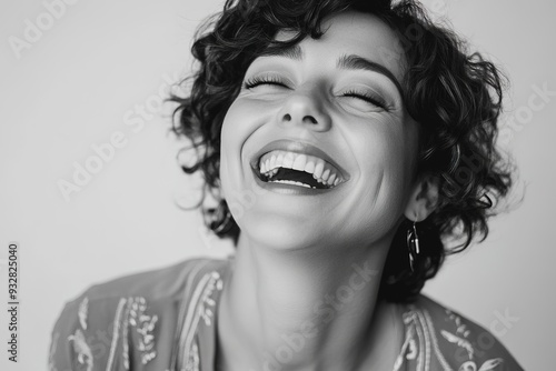 Laughing woman with curly hair, monochrome photo, joyful express