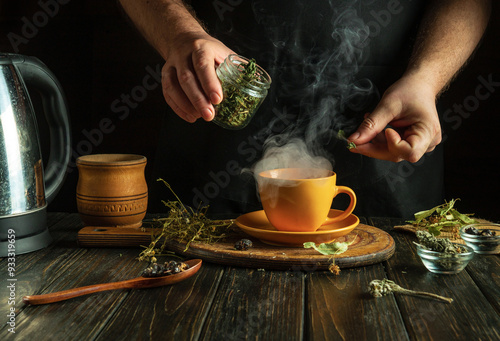 Herbalist prepares medicinal tea with mint and dry herbs in orange mug. Concept of traditional medicine at home.