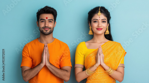 indian couple in traditional wear doing namaste