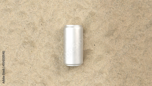 a white metal aluminum soda can on the sand at the beach