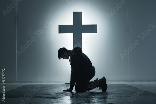 Silhouetted figure kneeling in prayer before a luminous cross in a foggy, mysterious forest at night.