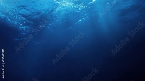 Deep Blue Abyss: Sunbeams pierce the surface of a deep blue ocean, illuminating the depths below. 