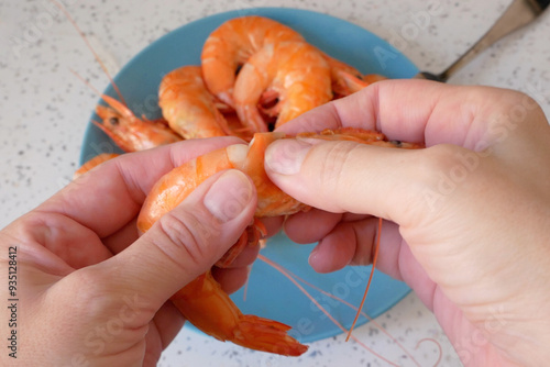 hands peeling the big king boiled prawns, testy seafood, shrimps,