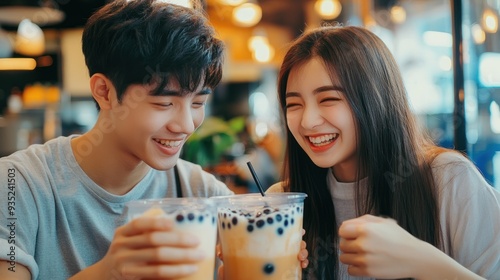 Happy Couple Enjoying Boba Tea Together in a Cafe