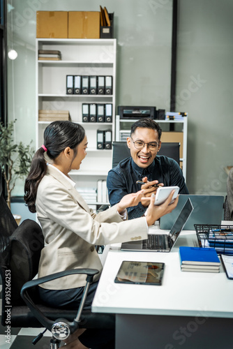 Asian colleagues meet at a desk, discussing business financial terms, investment strategies, managing funds. Their focus is on planning, analysis, and operations to ensure stability and success.