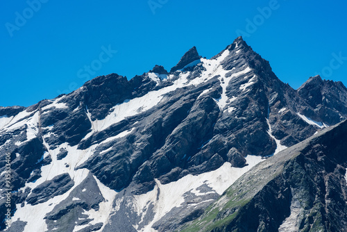 mountain landscape, view of sharp rock peak with snowfields and glaciers