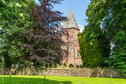 The Victorian church of St. Mary (opened in 1870) built of the local Old Red Sandstone in the village of Walton, Cumbria, England UK