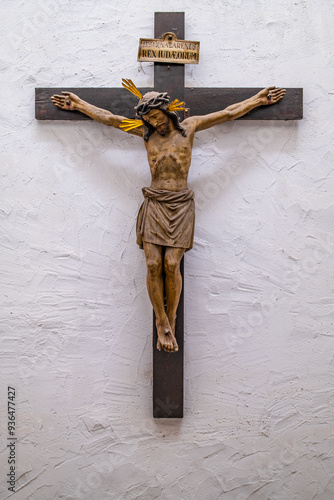 The historic wooden crucifix on a white wall.