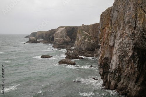 View of rugged cliffs and sea on a cloudy day. Pembrokeshire Coast National Park, Wales