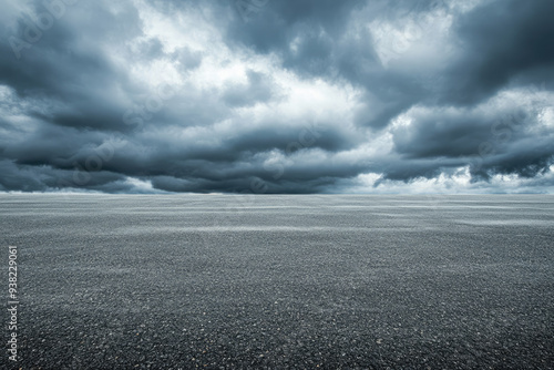 Dark storm clouds gathering over empty asphalt road