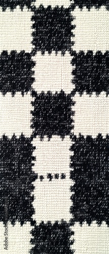 A black and white checkered blanket with white squares