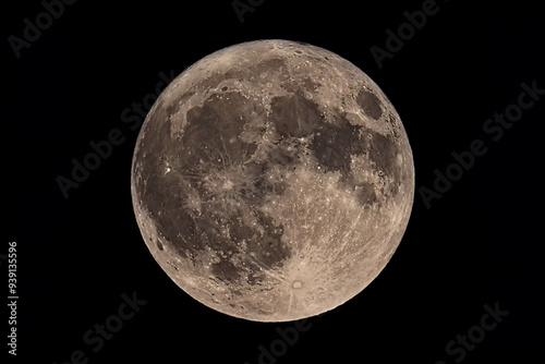 An original horizontal photograph of the super blue moon with dark night background - full moon as seen through a telescope