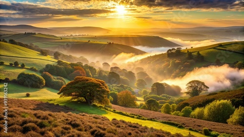 Misty dawn breaks over the rolling hills and wooded valleys of Exmoor National Park, with the sun casting a warm golden light on the rugged landscape.