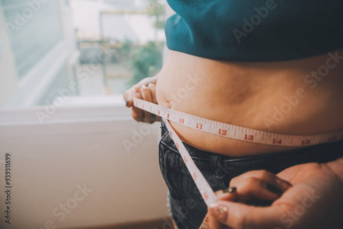 fat woman, fat belly, chubby, obese woman hand holding excessive belly fat with measure tape, woman diet lifestyle concept