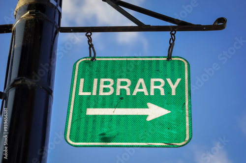 Library sign hanging in the metal pole