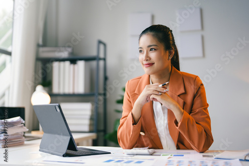 Businesswoman is smiling while looking away and thinking about a solution to a problem at the office