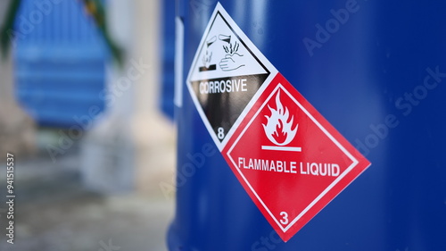 Corrosive warning sign label and flammable liquid warning sign label on the barrel tank. To warn that there are dangerous chemicals in the tank, please be careful.