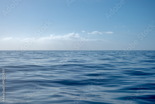 Tranquil landscape scene with ocean horizon and calm cloudscape