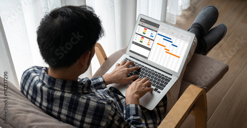 Project planning software for modish business project management on the computer screen showing timeline chart of the team project