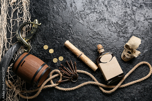 Skull with coins, rum, treasure map and rope on dark background. Pirate concept