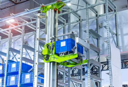 plastic boxes in the cells of the automated warehouse. Metal construction warehouse shelving