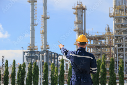 Refinery petroleum worker on duty radio control operation. Industrial Engineer in oil and gas working in petrochemical plant.