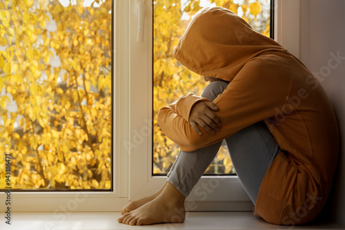 Stressed Deppressed Sad Teenager Girl in Autumn Window. Teenage Problems and Teen Mental Health.