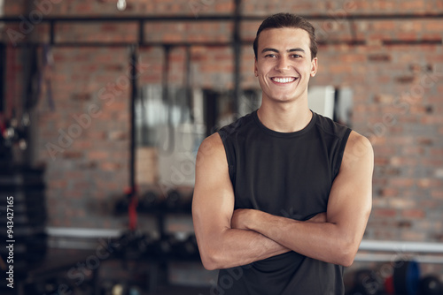 Man, portrait and confident in gym for fitness or daily workout routine, muscle growth and development. Male person, arms crossed and happy with pride in studio for exercise, cardio and training.