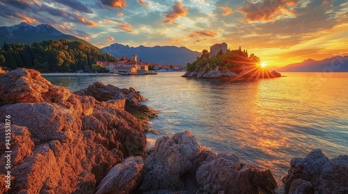 Exotic sundown over the tiny Sveti Stefan islet in Montenegro, Adriatic sea, Europe. A popular European travel destination and a testament to the beauty of our planet.