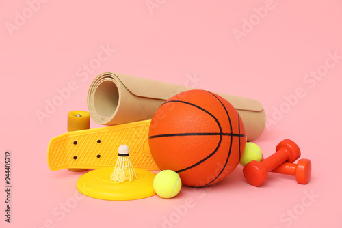 Different sports items on pink background