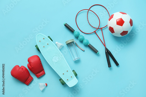 Set of sports equipment on blue background, top view