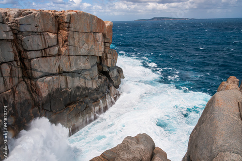 A coastal landscape featuring The Gap in Western Australia. Rugged cliffs rise above the crashing ocean waves, showcasing the raw power and beauty of nature. Perfect for travel and nature themes. 