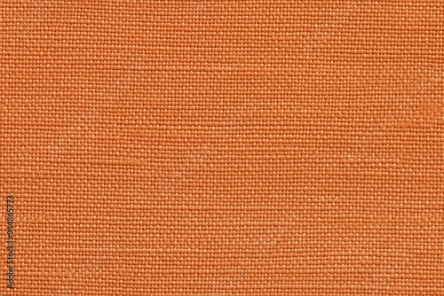 Textured orange batiste cotton fabric, showcasing a woven pattern and a warm hue.