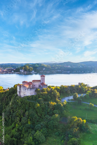 Vertical panoramic aerial view of Rocca Borromea of Angera city, Angera, Varese province, Lombardy, Italy 