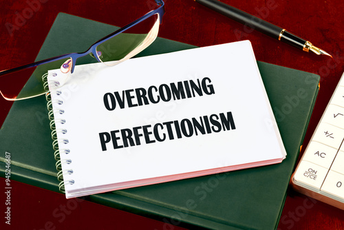 Business Overcoming perfectionism concept. Copy space. Concept words Overcoming perfectionism top view in notepad