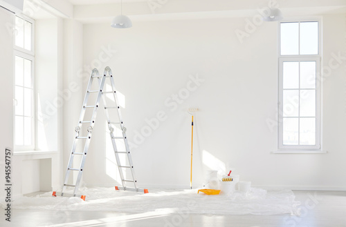 Empty room with painting equipment, brushes and colors for wall renovation during home or office construction project. Process of reconstruction and improvement in residential or commercial spaces.