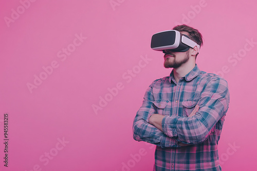 Immersed in a New Reality: A man wearing VR goggles with a contemplative expression, standing against a vibrant pink background, embodies the potential and wonder of virtual reality. 