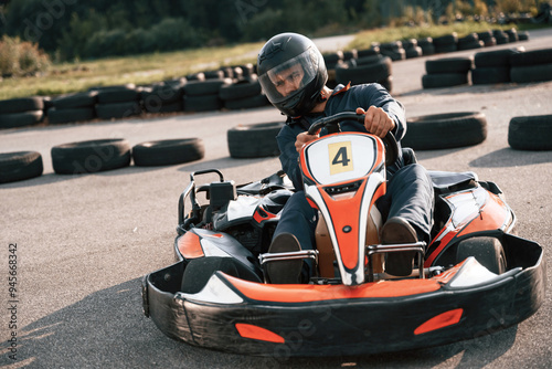 Competition, riding. Man is outdoors, kart racing conception